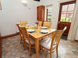 A dining room with a table set for meals at Beechwood in Wood Norton
