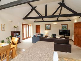 A living room with a sofa and television at Beechwood in Wood Norton