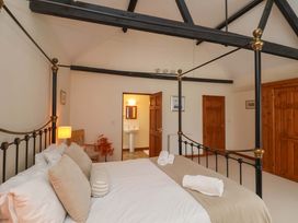 A bedroom with a bed and sink at Beechwood in Wood Norton