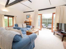 A living room with a sofa, coffee table and television at Willow, Wood Norton near Foulsham