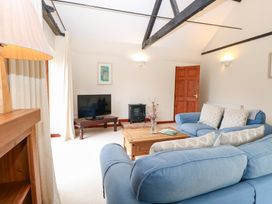 A living room with a sofa and television at Willow in Wood Norton near Foulsham