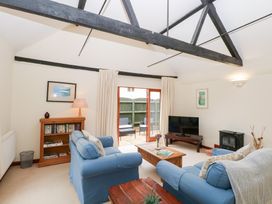 A living room with furniture and a television at Willow near Wood Norton