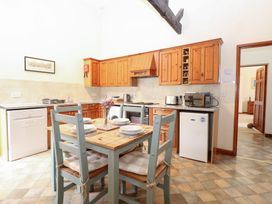 A kitchen with a dining table and chairs at Willow in Wood Norton near Foulsham