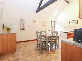 A kitchen with a dining table and chairs at Willow in Wood Norton near Foulsham