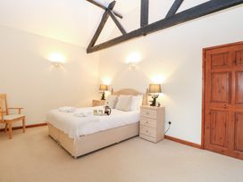 A bedroom with a bed and bedside table at Willow in Wood Norton near Foulsham