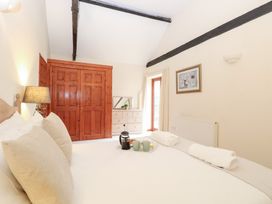 A bedroom with a bed, wardrobe, dresser and window at Willow in Wood Norton near Foulsham