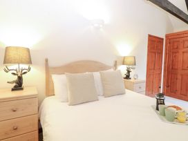 A bedroom with a bed and bedside table at Willow in Wood Norton near Foulsham