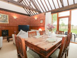A dining room with a table and chairs at Pear Tree in Wood Norton