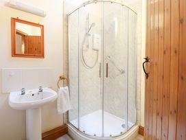 A bathroom with a shower and a hand basin at Pear Tree in Wood Norton