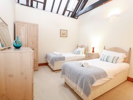 A bedroom with two beds and a dresser at Pear Tree in Wood Norton