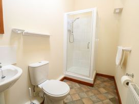 A bathroom with a toilet sink and shower enclosure at Holly Berry in Wood Norton near Foulsham