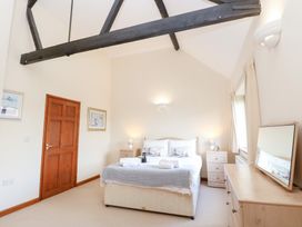 A bedroom with a bed and bedside tables at Holly Berry Wood Norton near Foulsham