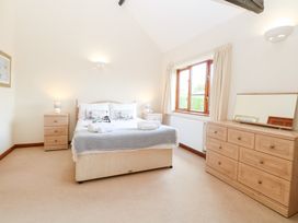 A bedroom with a bed and bedside tables at Holly Berry in Wood Norton near Foulsham