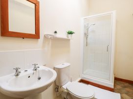 A bathroom with shower and sink at Holly Berry Wood Norton near Foulsham