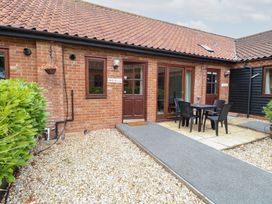 An outdoor area with a table and chairs at Holly Berry near Foulsham