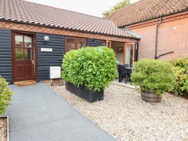 An entrance with plants and seating at Sycamore in Wood Norton near Foulsham
