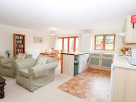 A living room and kitchen with seating and dining area at Sycamore in Wood Norton near Foulsham