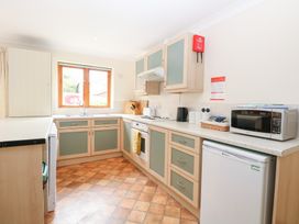 A kitchen with appliances and cabinets at Sycamore in Wood Norton near Foulsham