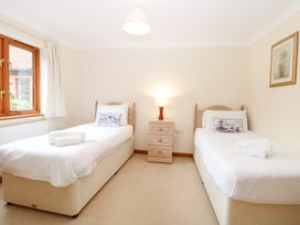 A bedroom with two single beds in Sycamore Wood Norton near Foulsham