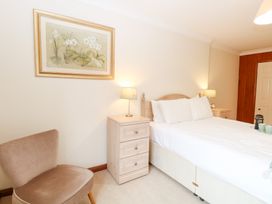 A bedroom with a bed and nightstand at Sycamore in Wood Norton near Foulsham