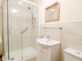 A bathroom with a shower and sink at Sycamore Wood Norton near Foulsham