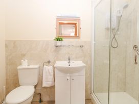 A bathroom with a shower and sink at Sycamore Wood Norton near Foulsham