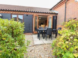 An outdoor area with a table and chairs at Sycamore in Wood Norton near Foulsham