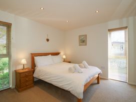 A bedroom with a double bed and two bedside tables with lamps at Chestnut Lodge in Clunton near Clun