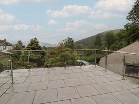 An outdoor balcony with a glass railing at High Cross in Keswick