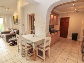 A kitchen with a table and chairs at High Cross in Keswick