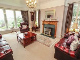 A living room with furniture including sofas and a fireplace at High Cross in Keswick