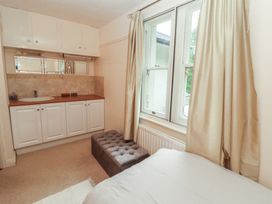 A bedroom with a bed, window and vanity at High Cross in Keswick