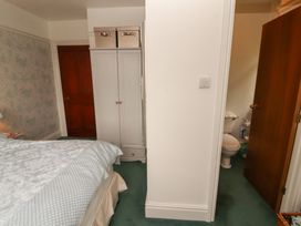 A bedroom with a bed and wardrobe at High Cross in Keswick