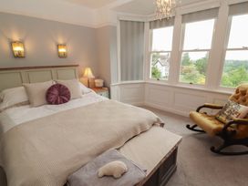 A bedroom with a bed and a rocking chair at High Cross in Keswick