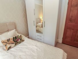 A bedroom with a bed and wardrobe at High Cross in Keswick