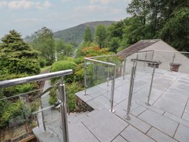 A patio with steps and railing overlooking a garden at High Cross in Keswick