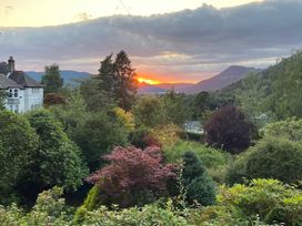 A sunset view with trees and a house at High Cross in Keswick