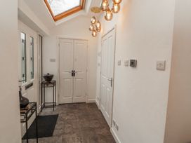 A hallway with a door and a light fixture at High Cross in Keswick