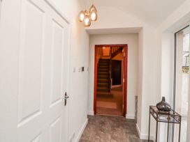 A hallway with a staircase and door at High Cross in Keswick
