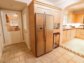 A kitchen with a refrigerator and cabinets at High Cross in Keswick