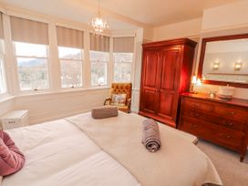 A bedroom with a bed and wardrobe at High Cross in Keswick