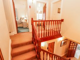 A hallway with a staircase and doors at High Cross in Keswick