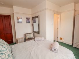 A bedroom with a bed and decorative items at High Cross in Keswick