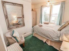 A bedroom with a bed and a nightstand at High Cross in Keswick