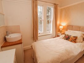 A bedroom with a bed and a sink at High Cross in Keswick
