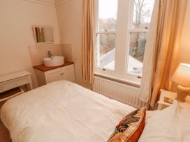 A bedroom with a bed and sink at High Cross in Keswick