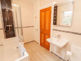 A bathroom with a bathtub, sink, and shower at High Cross in Keswick
