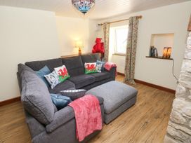 A living room with a sofa and window at Dolcoed near Llangadog