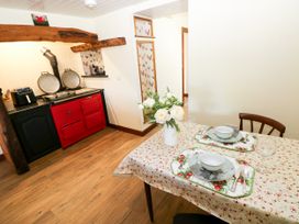 A dining area with a table set in a kitchen at Dolcoed Manordeilo near Llangadog