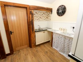 A kitchen with a sink and cabinets at Dolcoed in Manordeilo near Llangadog